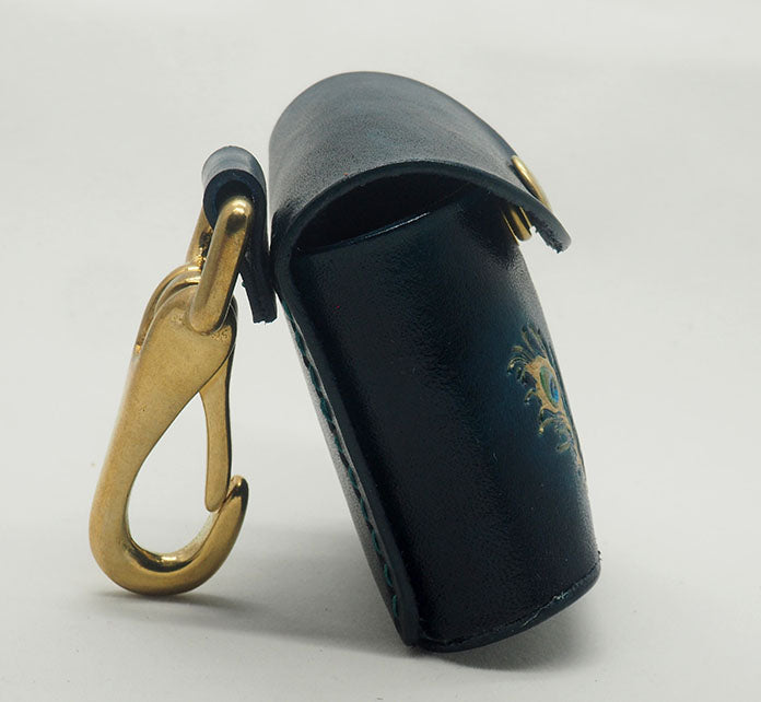 Peacock teal leather dog waste bag dispenser with solid brass hardware.  Photographed from the side to show the solid brass clip and the contrast stitching.